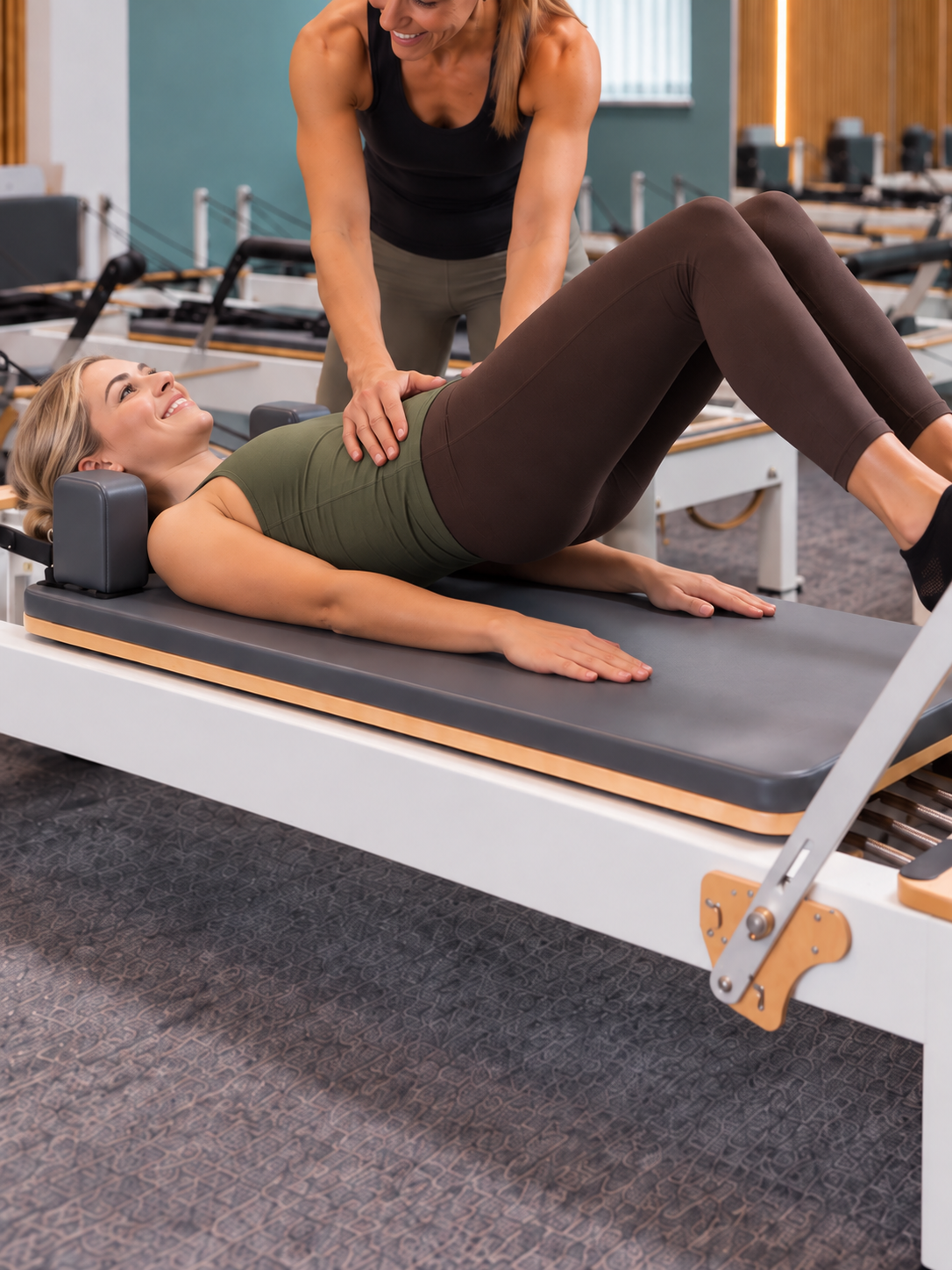 An instructor guiding a first-time client through a reformer exercise